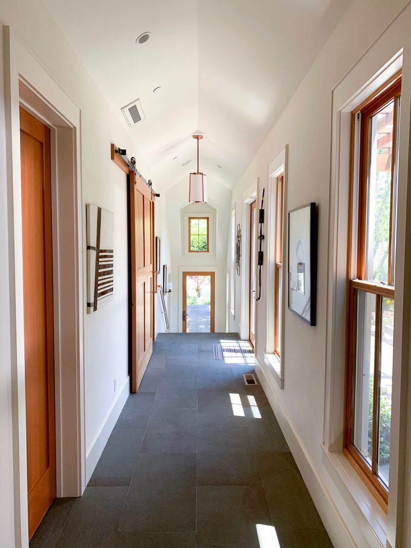 Light-filled hallway with barn doors